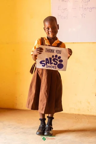 girl holding thank you sign